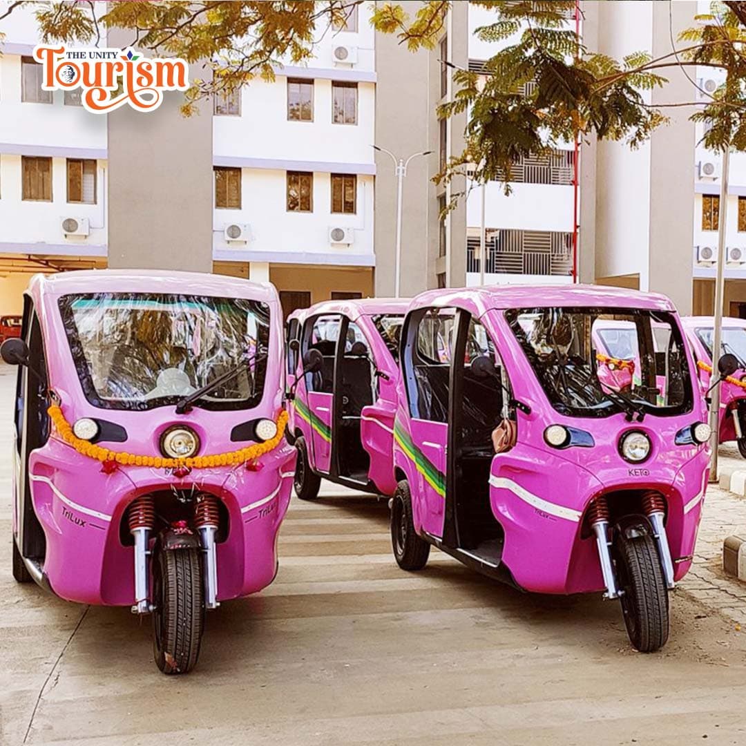 Fleet of pink electric rickshaws lined up for tourism service at Statue of Unity campus