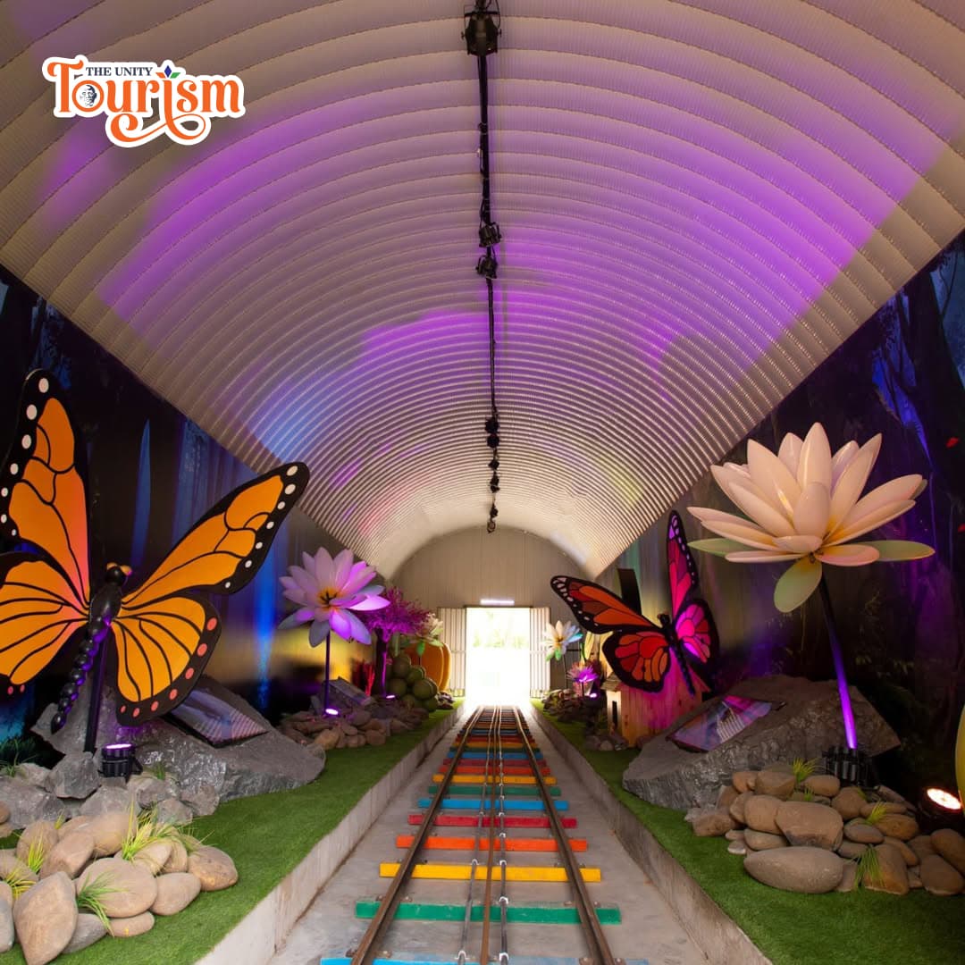Colorful butterfly garden tunnel with giant butterfly and flower decorations near Statue of Unity