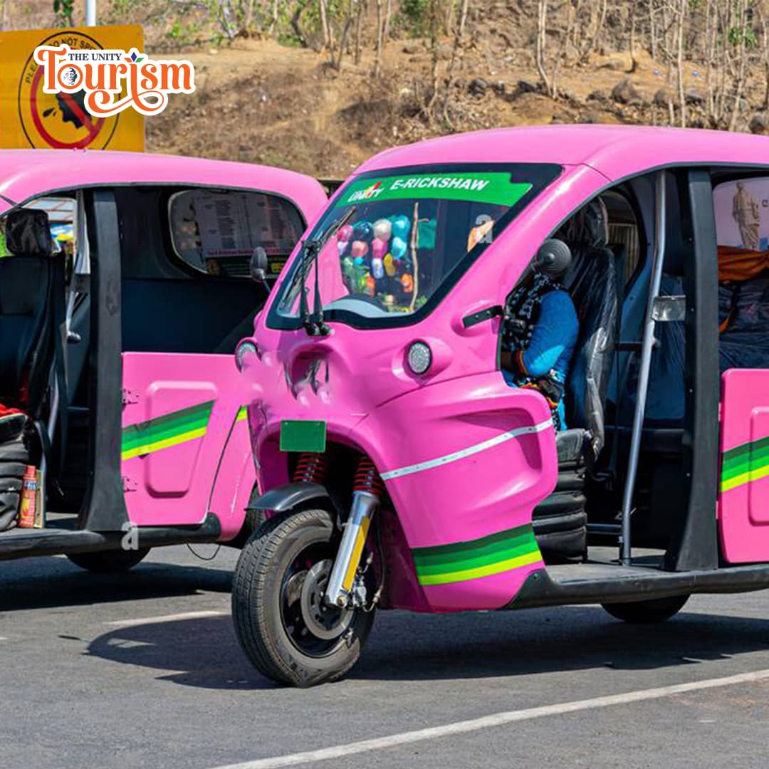 Close-up view of vibrant pink e-rickshaw ready for eco-tourism at Statue of Unity