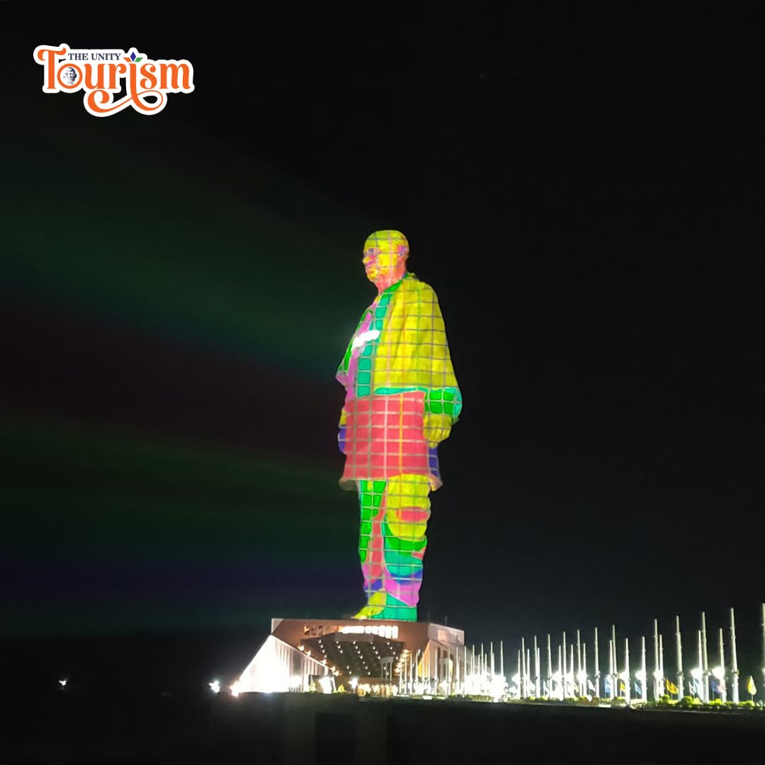 Tourists watching projection mapping light show on Statue of Unity.