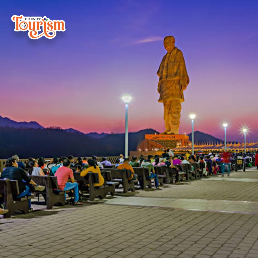 Colorful evening laser light projection highlighting Statue of Unity.