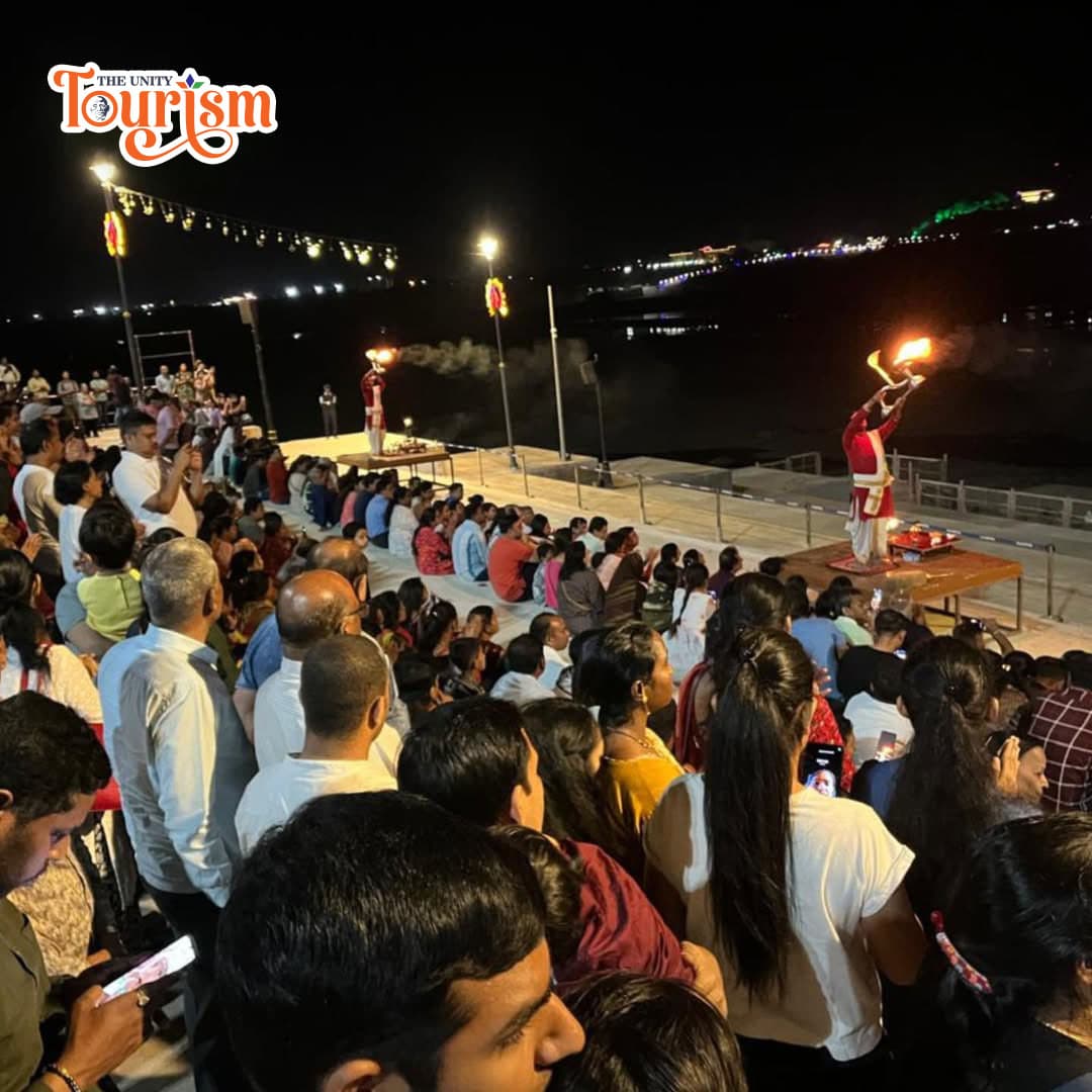 People admire Pooja ceremony lighting up the sky during the Narmada Maha Aarti at the riverfront by the Statue of Unity.
