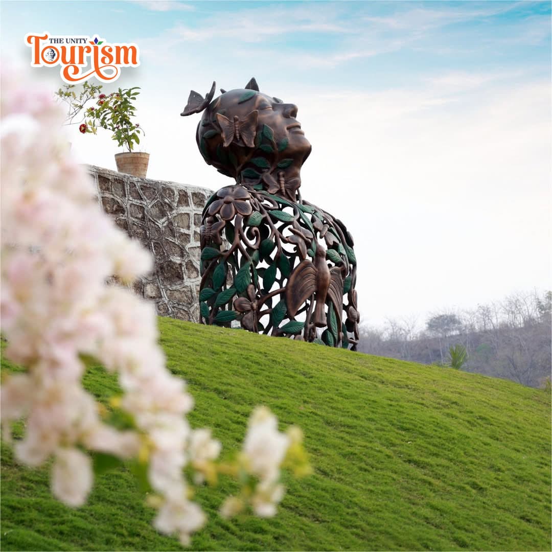 Artistic sculpture of a human figure made with floral and leafy patterns at Arogya Van.