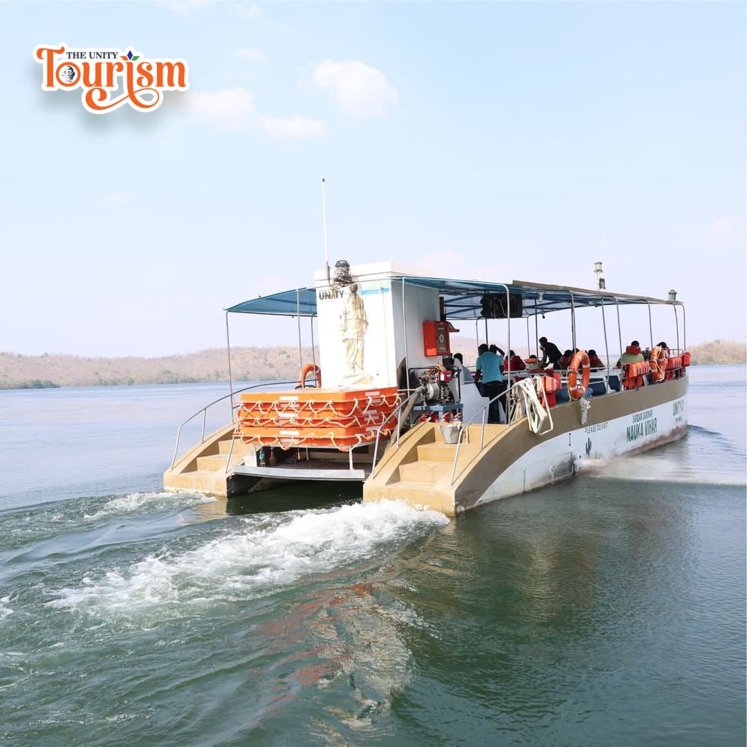 A group of people enjoys a boat ride on calm waters, surrounded by nature.