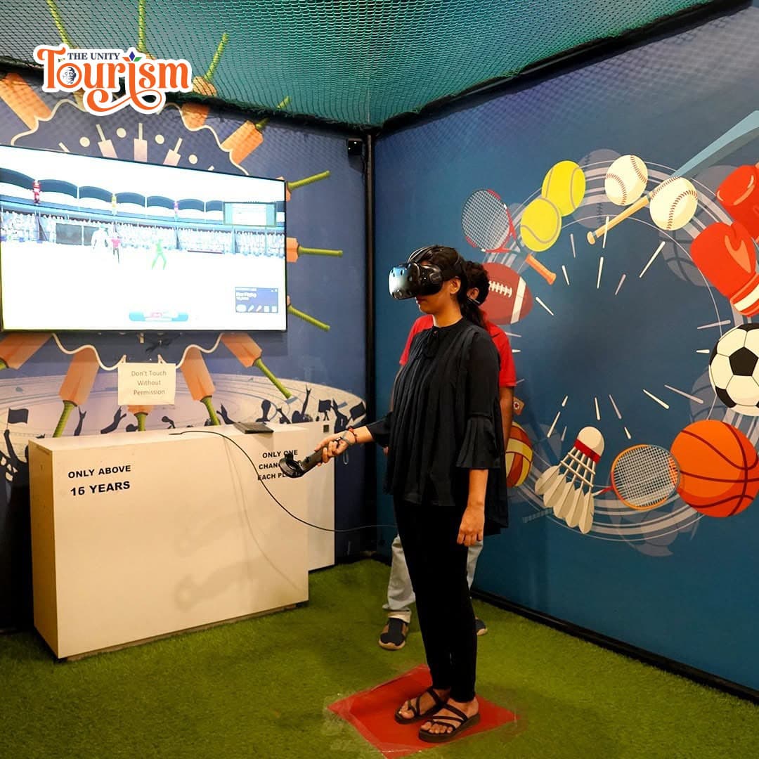 Colorful floral-themed building at Statue of Unity with vibrant artwork and garden view – The Unity Tourism