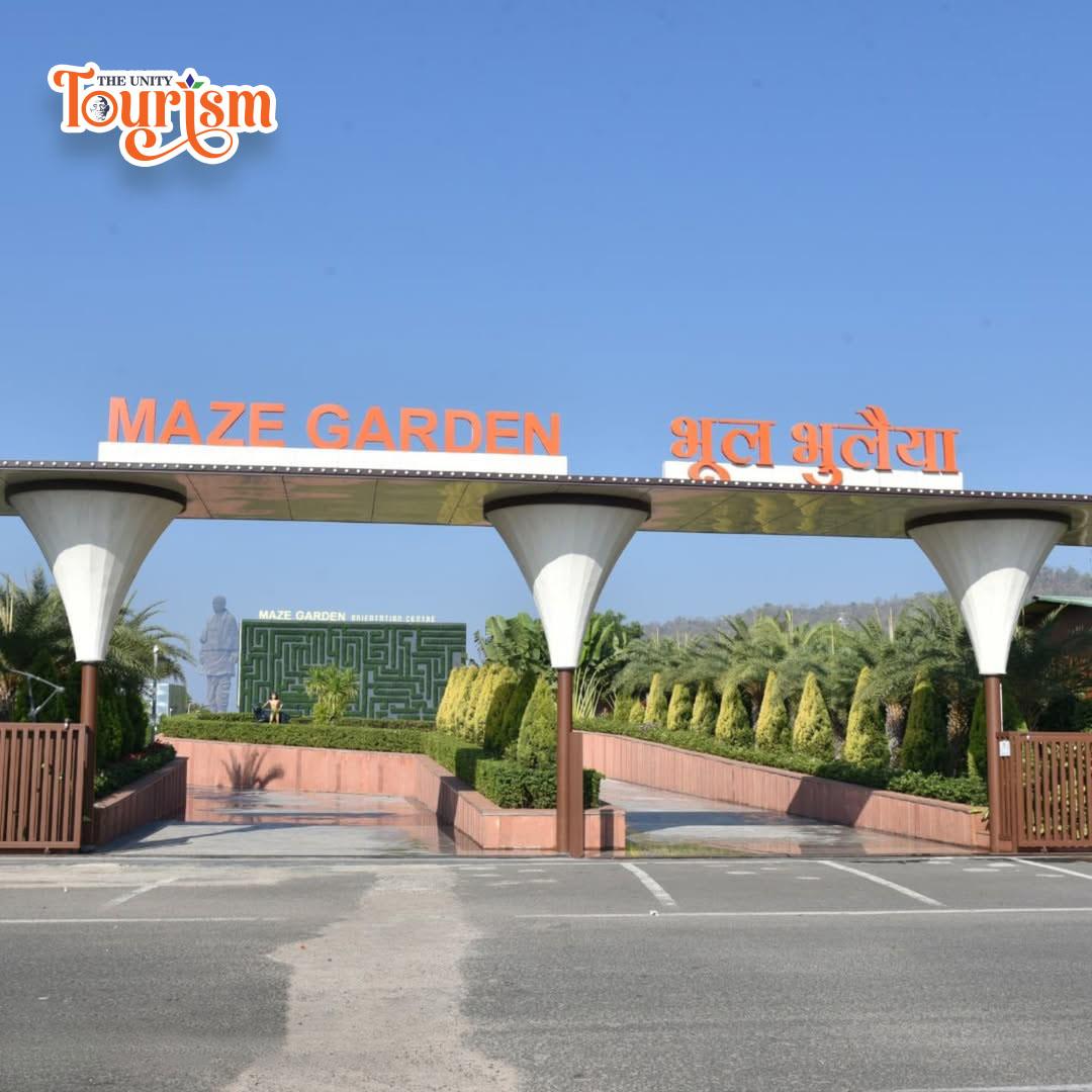 The entrance to Maze Garden at Statue of Unity, showcasing vibrant plants against the backdrop of a contemporary structure.