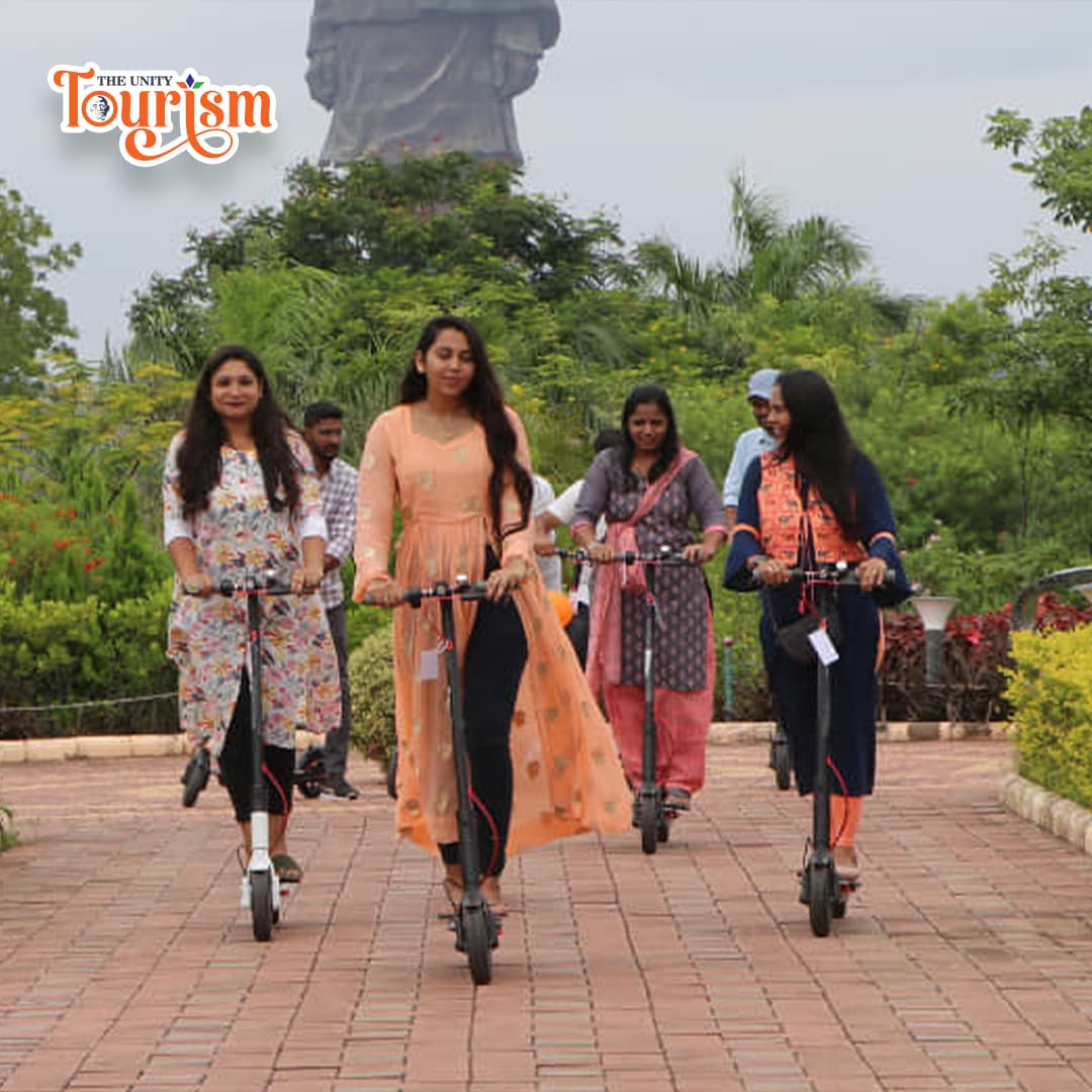 Group enjoying electric kick scooter ride at Statue of Unity campus.