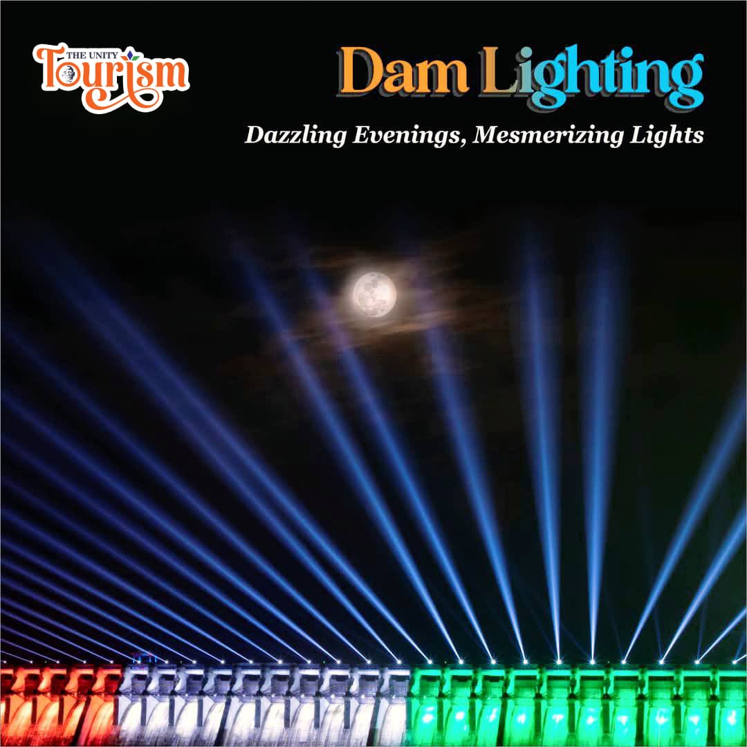 Aerial view of Sardar Sarovar Dam surrounded by lush green hills near Statue of Unity.