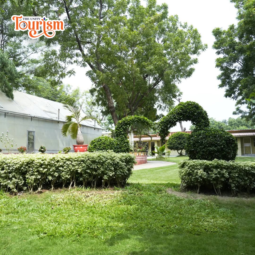Scenic pathway with colorful flower beds at Valley of Flowers near Narmada River.