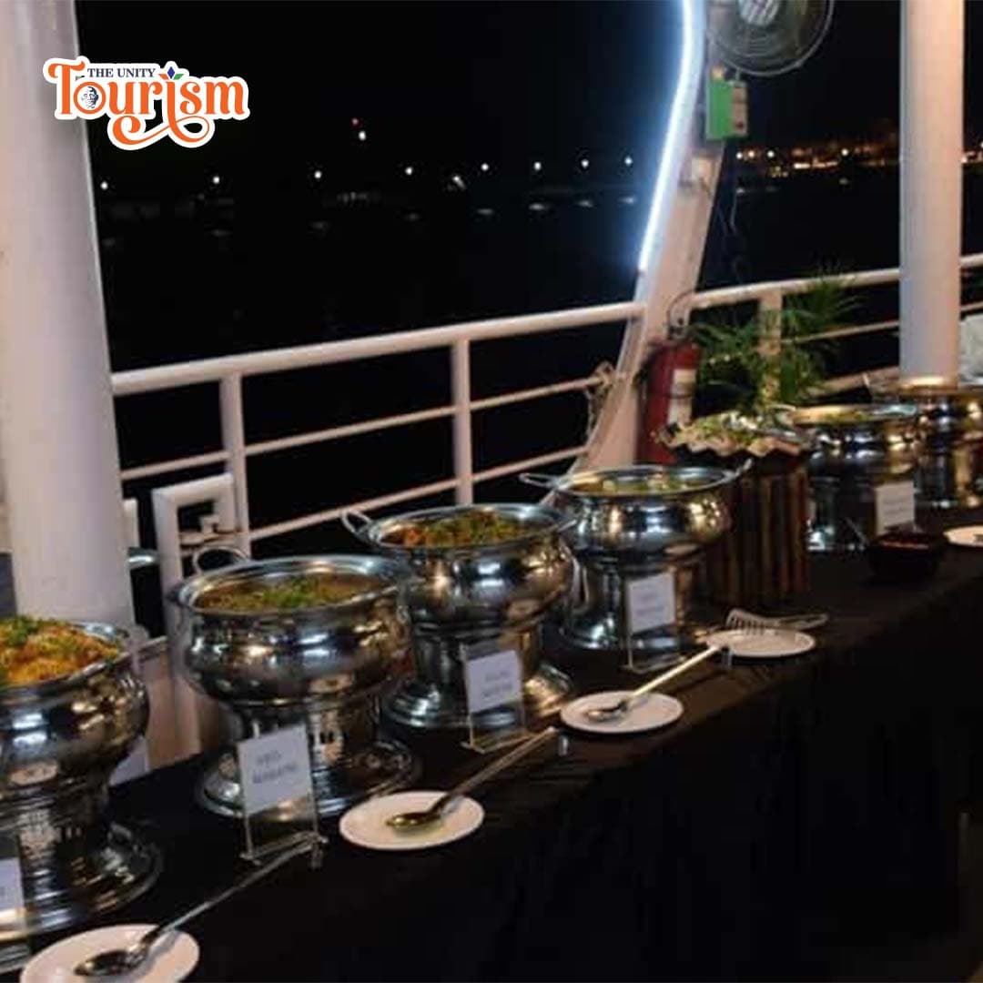 Guests enjoying their dinner in an open-air dining area onboard the Ekta Dinner Cruise.