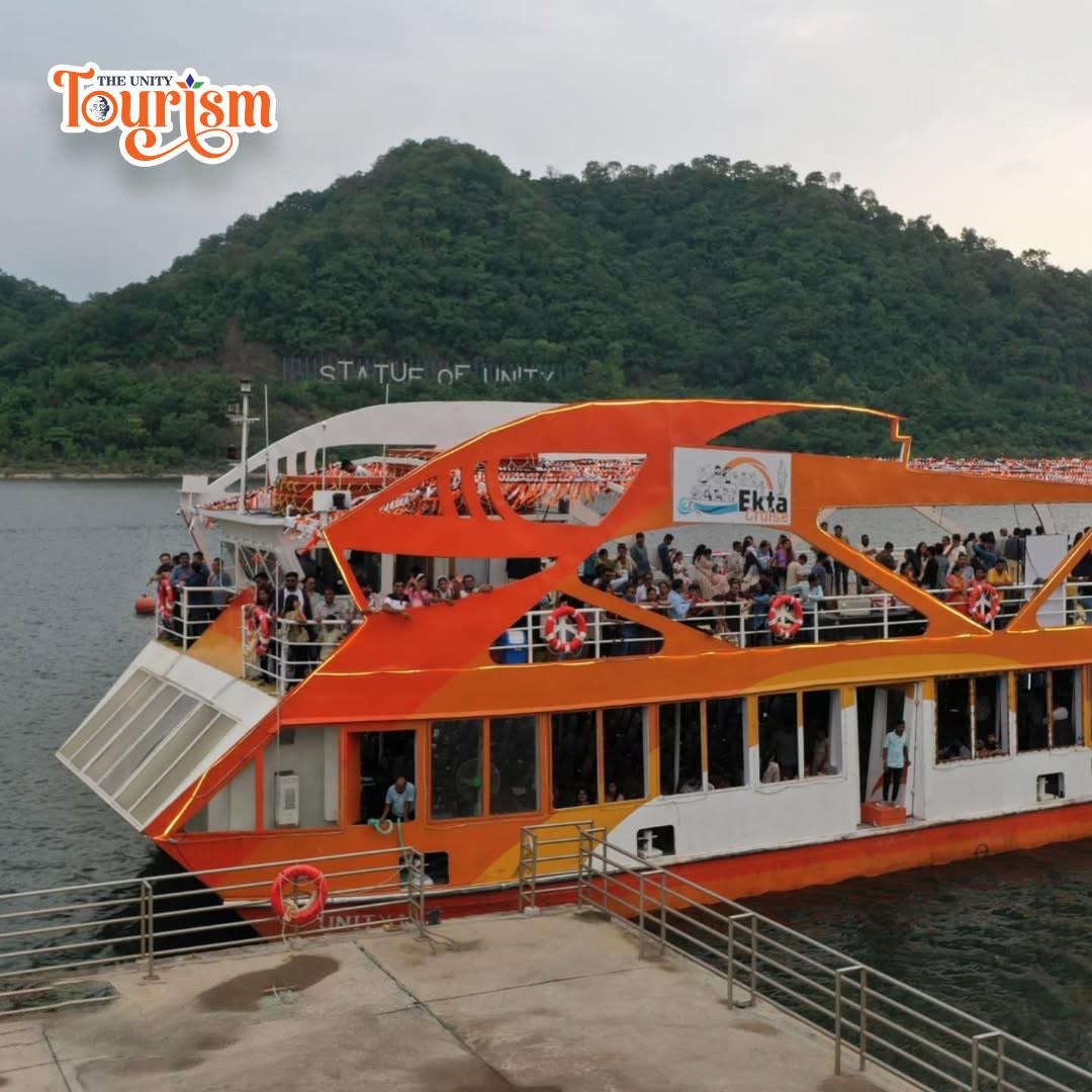 Crowds boarding the bright orange Ekta Cruise at Kevadia jetty.