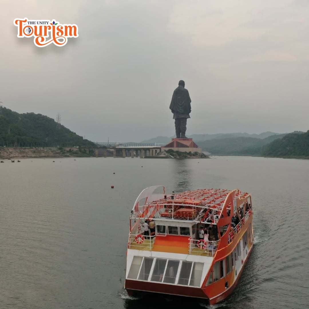 Ekta Cruise sails on Narmada River with Statue of Unity towering in the background.