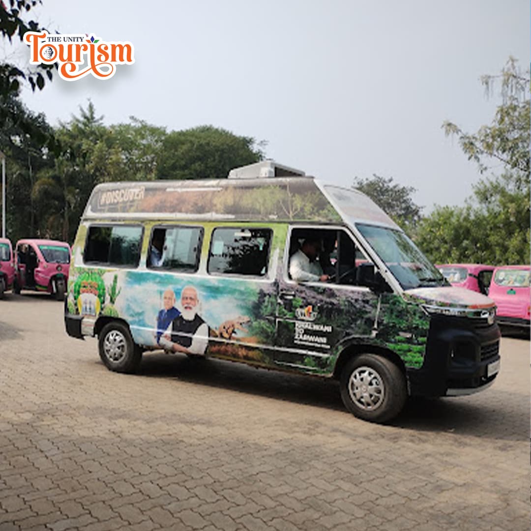  A parked van in front of a lush cactus garden, showcasing various cactus species.