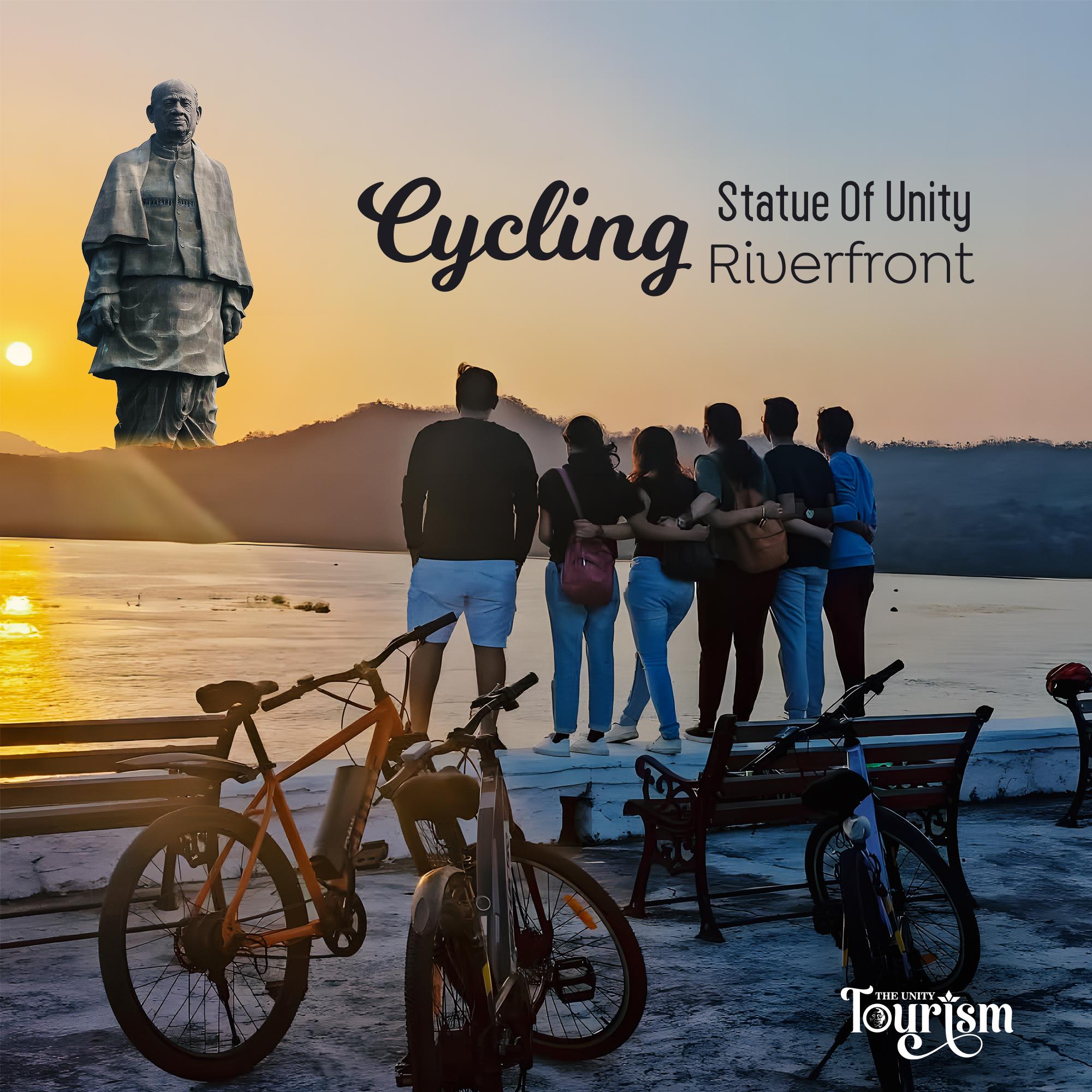Group of tourists enjoying sunset at Statue of Unity riverfront with bicycles parked nearby, promoting cycling activity
